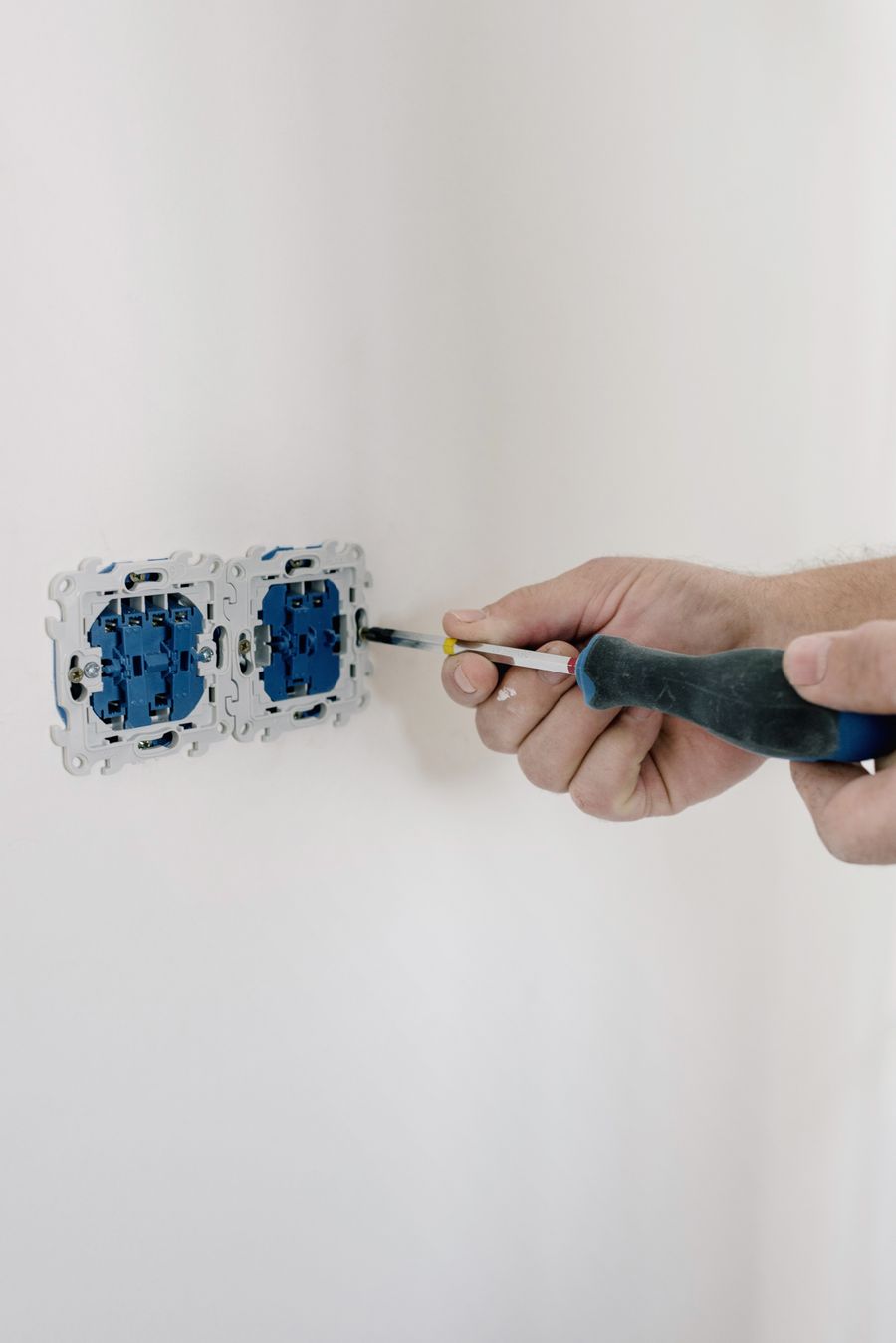 Electrician working on a wall switch